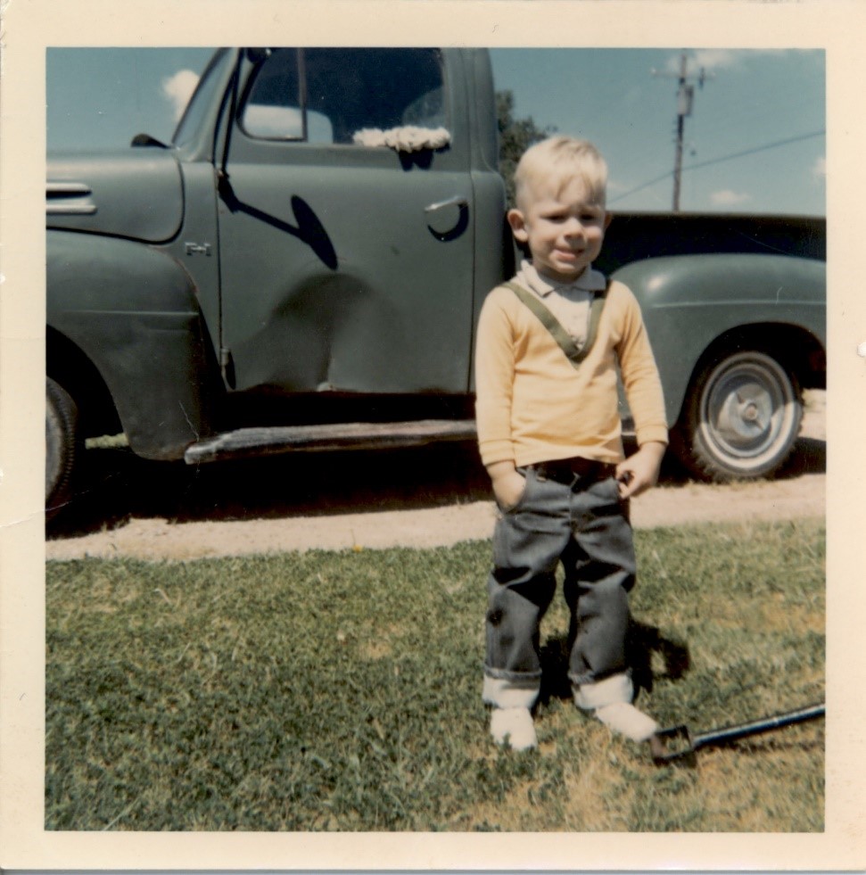 Brian Fowler, mid 1960s in front of his dad’s truck in Pantex Village