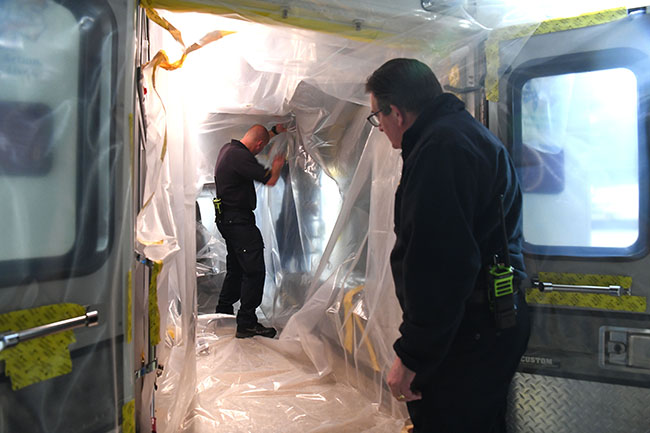 Members of the Pantex Fire Department install a Biocell Ambulance Protective System