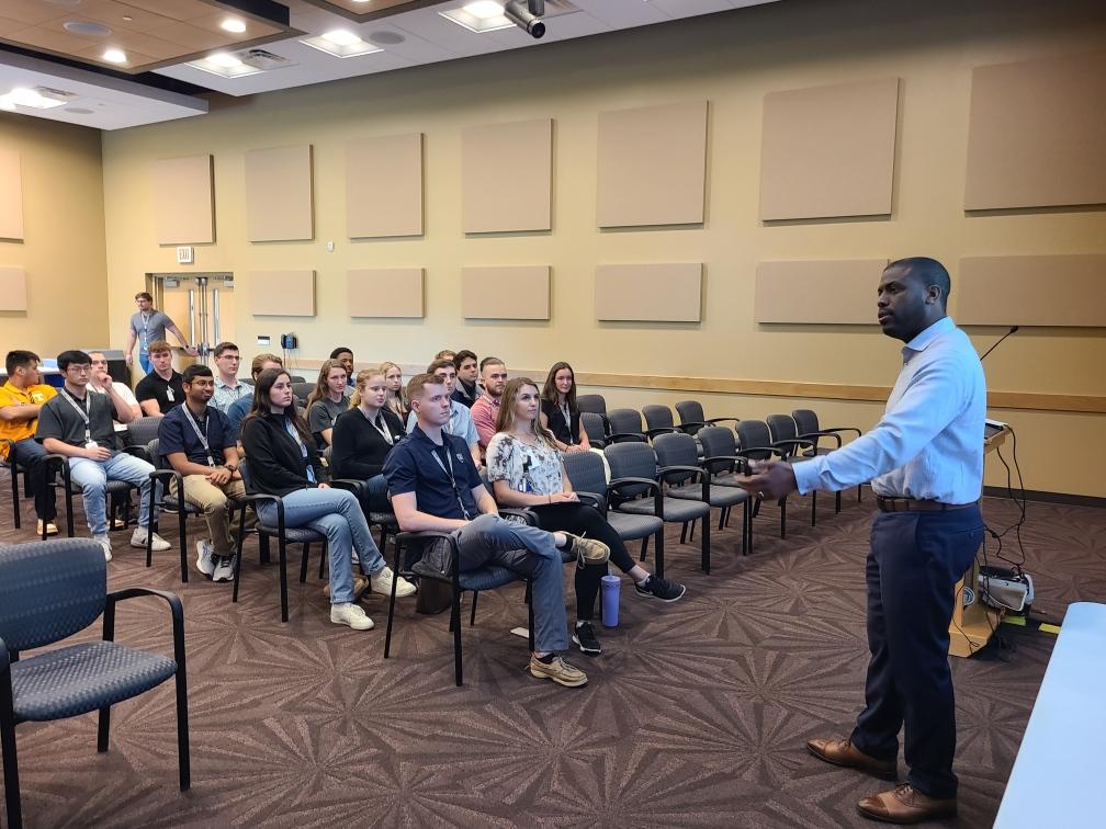 CNS interns and co-op students are pictured at a 2023 seminar featuring Jahleel Hudson, Director of NNSA’s Office of Technology and Partnerships.