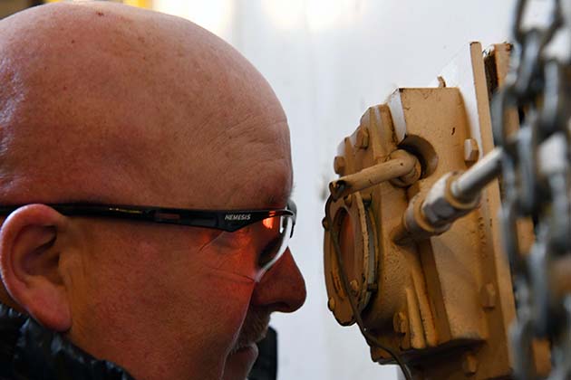 Deputy Site Manager Kenny Steward examines the sight glass, which give him a look inside one of the Pantex boilers. Deputy Site Manager Kenny Steward examines the sight glass, which give him a look inside one of the Pantex boilers.